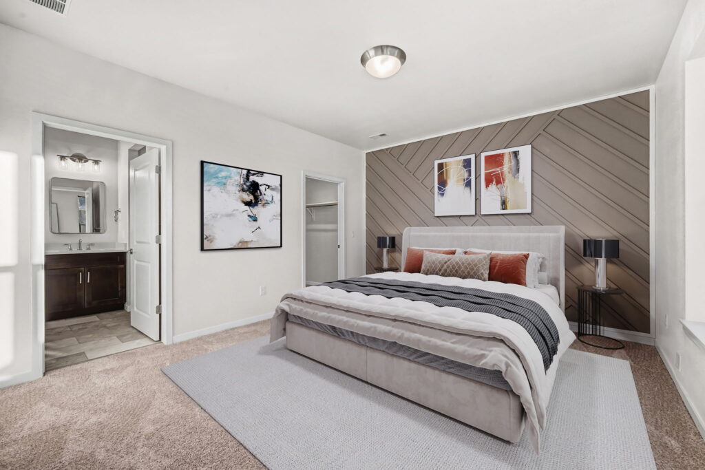 Modern bedroom with bathroom and abstract art.